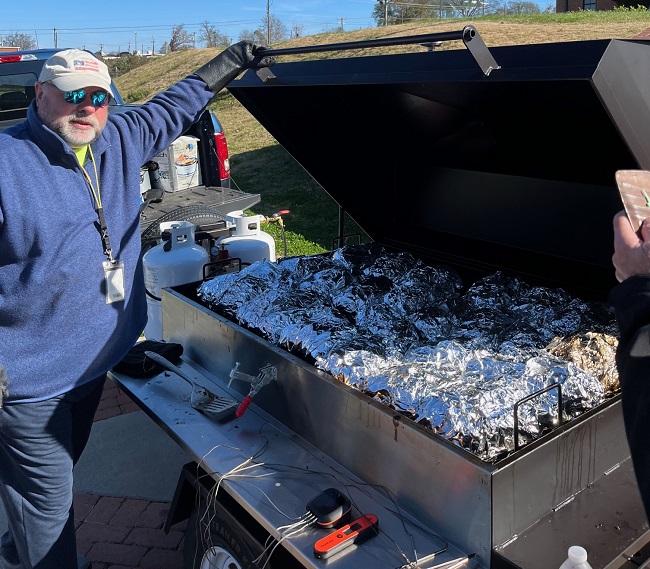 BBQ Tailgating master Marcus Miller with his pride & joy pull behind tailgating smoker - LOADED with pork shoulders.