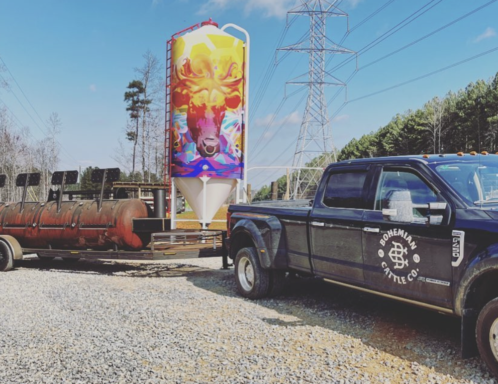 Bohemian Cattle Company's BBQ smoker and decoratively painted grain hopper.