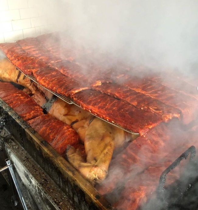 Easton Barbecue Co smoker filled with whole hog, ribs and smoke.