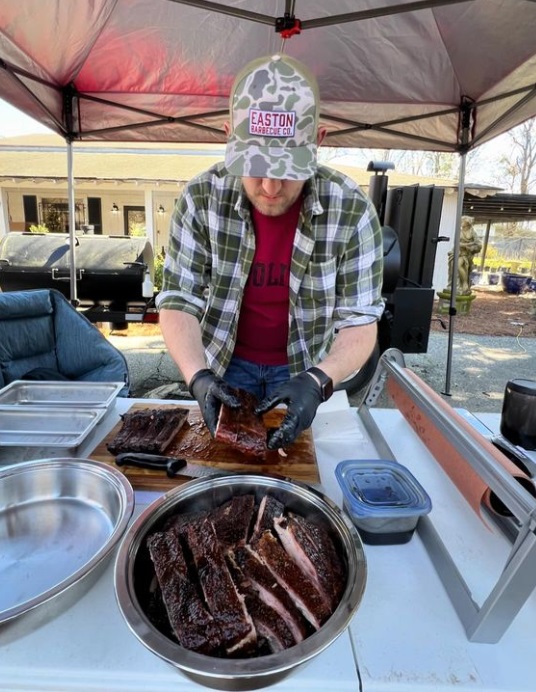 Easton Barbecue Co. pitmaster Joel Eason serves smoked ribs.