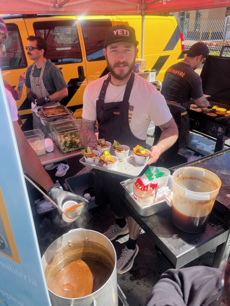 Lawrence Food Company Mastermind Jake Wood services smoked birria tacos with avacado salsa and consomme dipping sauce during the 2024 Carolina BBQ Festival. 