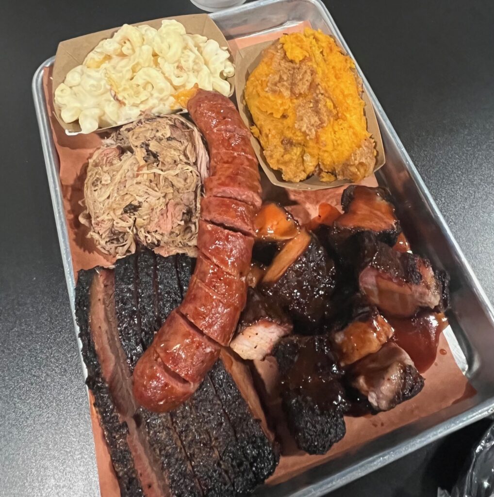 A barbecue tray from Fox Grove BBQ in Anderson, S.C., with puled pork, sausage, brisket, pork belly burnt ends, sweet potato crisp and white macaroni & cheese