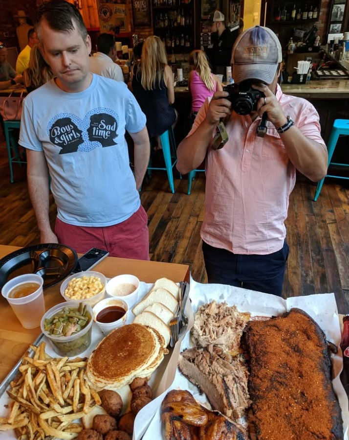 Barbecue Bros take pictures of barbecue trays.