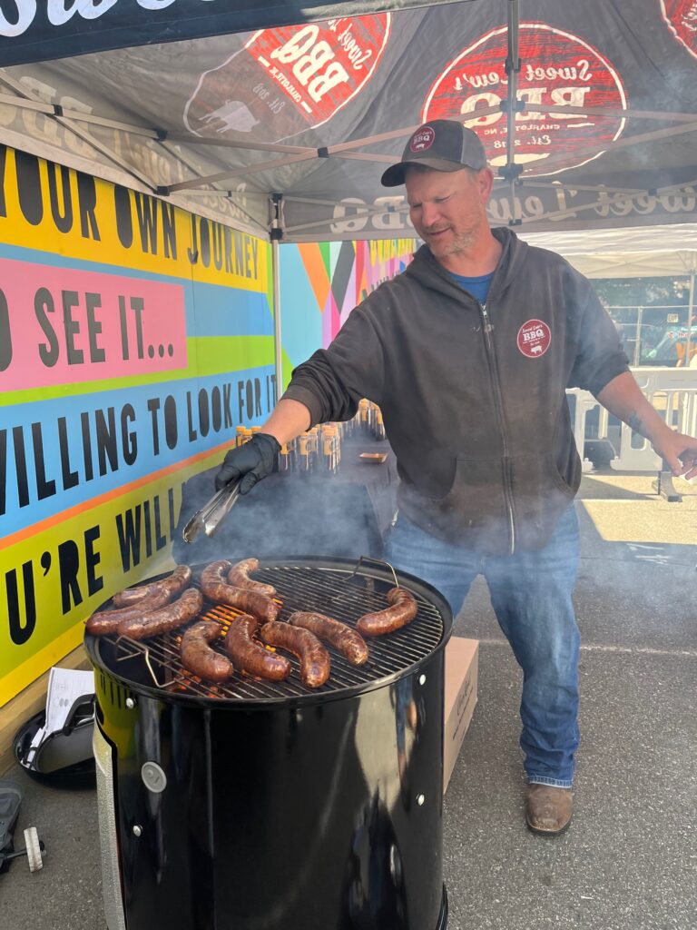 Lewis Donald cooks his signature sausage on a smoker.