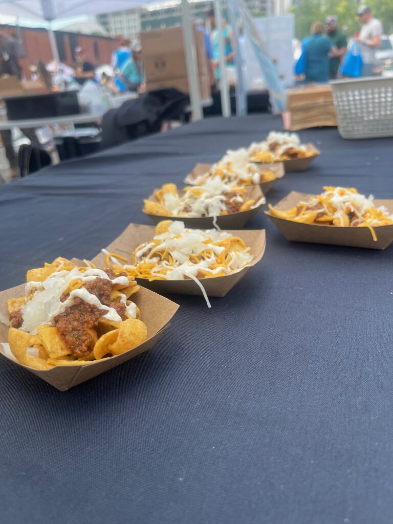 Trays of little Frito's with brisket chili, onions, and cheese.